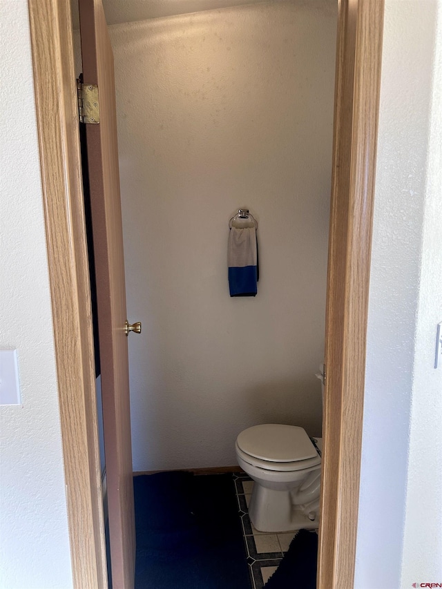 bathroom with tile patterned floors and toilet