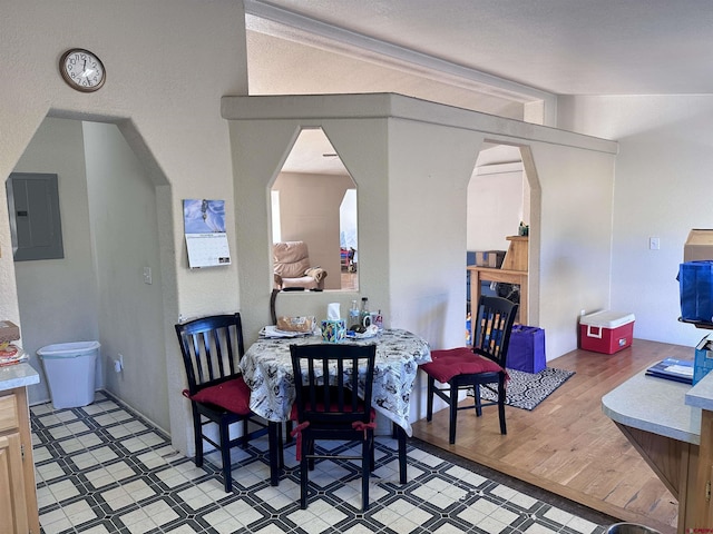 dining space with light wood-type flooring and electric panel