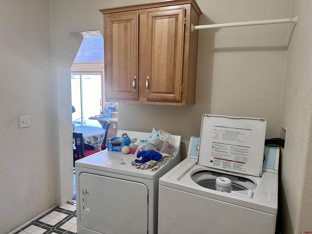 laundry area featuring cabinets and washing machine and clothes dryer