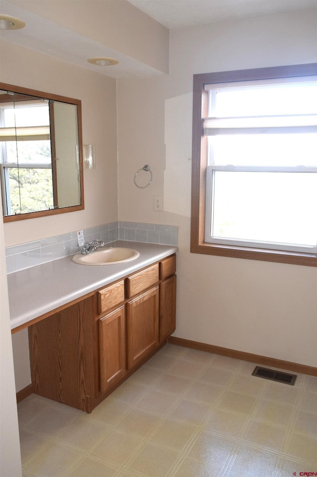 bathroom featuring vanity and a wealth of natural light