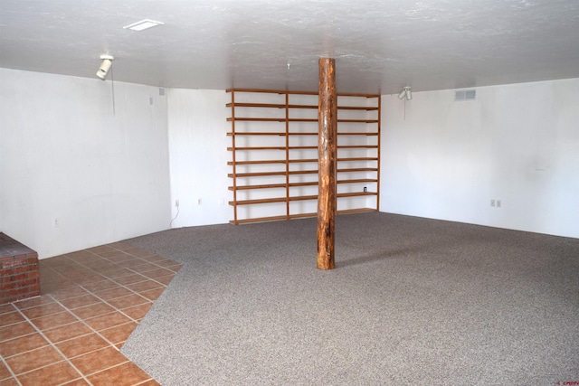 basement featuring a textured ceiling