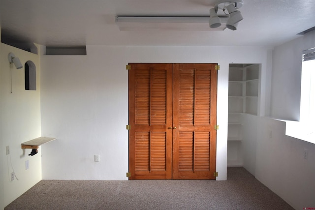 unfurnished bedroom featuring carpet flooring and a closet