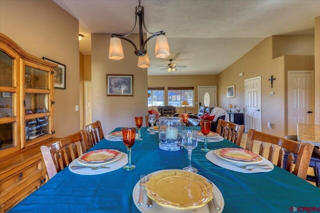 dining space featuring ceiling fan and lofted ceiling