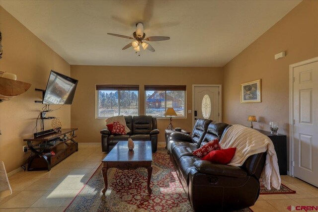 tiled living room featuring ceiling fan and lofted ceiling