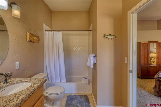 full bathroom featuring tile patterned flooring, vanity, shower / tub combo, and toilet