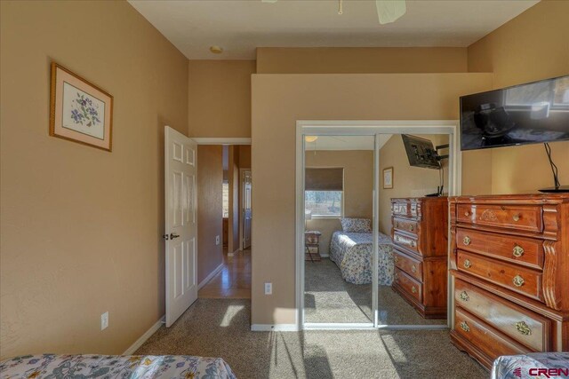 carpeted bedroom with a closet and ceiling fan