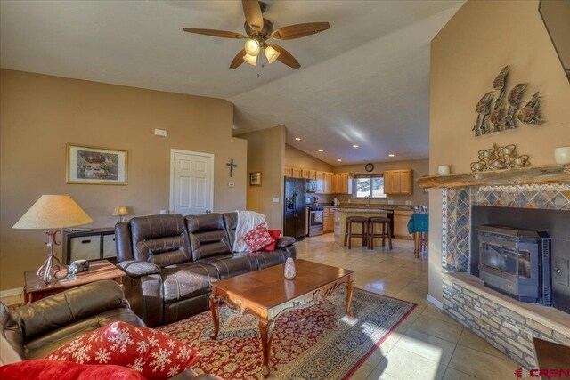 tiled living room featuring ceiling fan and lofted ceiling