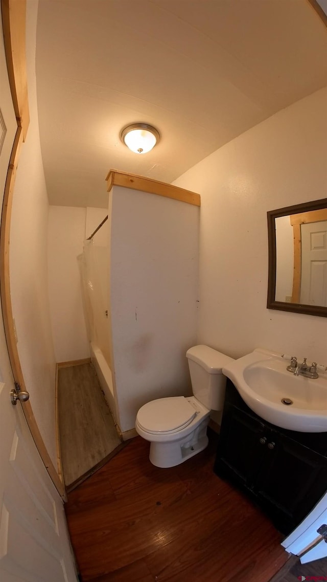 bathroom with vanity, hardwood / wood-style flooring, toilet, and walk in shower