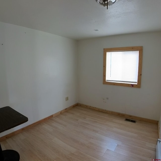 spare room with light hardwood / wood-style floors