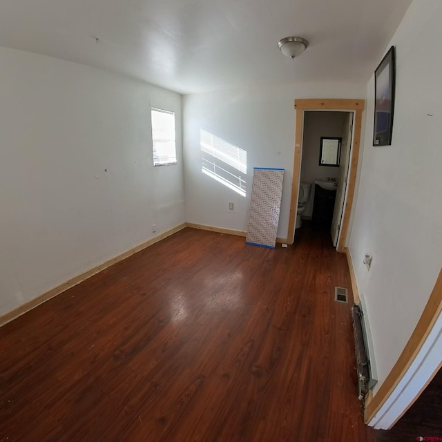 empty room featuring dark wood-type flooring