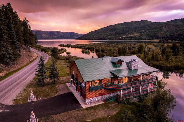 aerial view at dusk with a water and mountain view