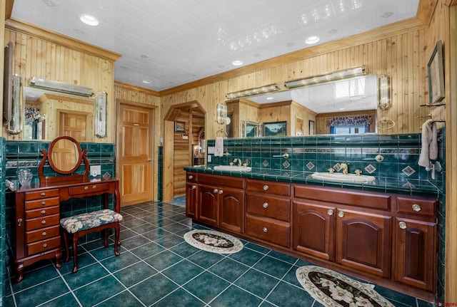 kitchen with backsplash, dark tile patterned floors, crown molding, and sink