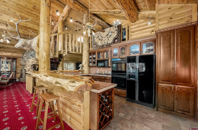 kitchen featuring beam ceiling, a kitchen breakfast bar, high vaulted ceiling, kitchen peninsula, and black appliances