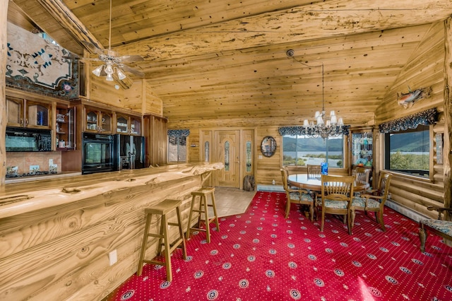 carpeted dining space featuring wood walls, ceiling fan with notable chandelier, wooden ceiling, and vaulted ceiling