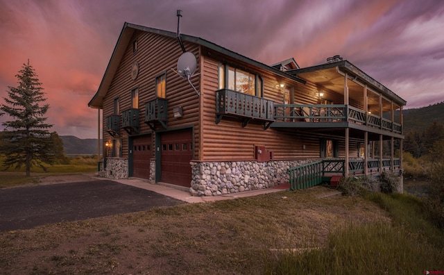 property exterior at dusk featuring a garage