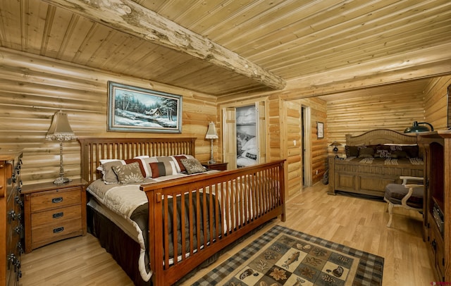 bedroom featuring beam ceiling, light hardwood / wood-style flooring, and wooden ceiling