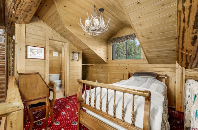 bedroom featuring ensuite bathroom, vaulted ceiling, and wooden walls