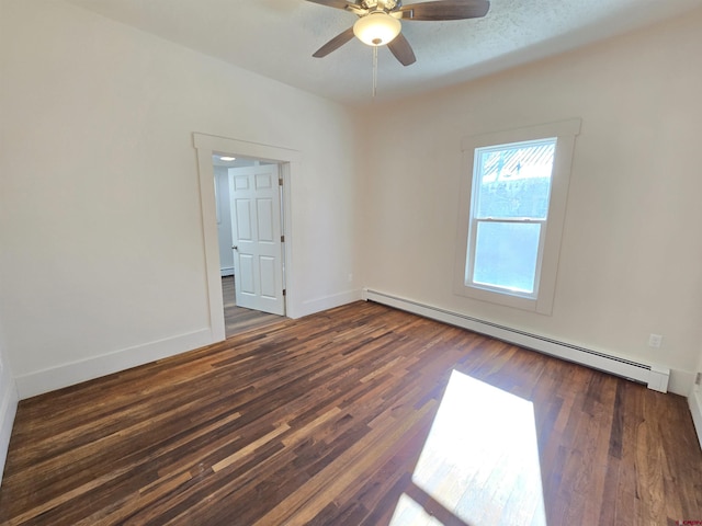 unfurnished room with dark hardwood / wood-style flooring, a baseboard radiator, and ceiling fan