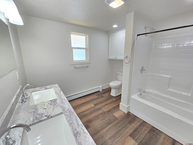 full bathroom featuring baseboard heating, wood-type flooring, toilet, vanity, and shower / bathtub combination