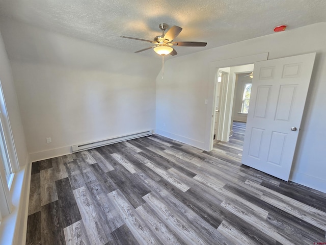 spare room with ceiling fan, dark hardwood / wood-style flooring, a textured ceiling, and a baseboard heating unit