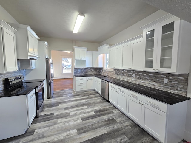 kitchen with tasteful backsplash, white cabinetry, sink, and appliances with stainless steel finishes