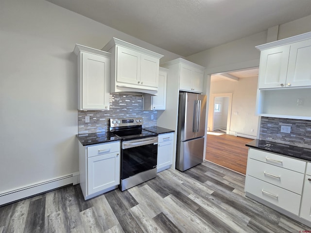 kitchen with white cabinets, light wood-type flooring, baseboard heating, tasteful backsplash, and stainless steel appliances