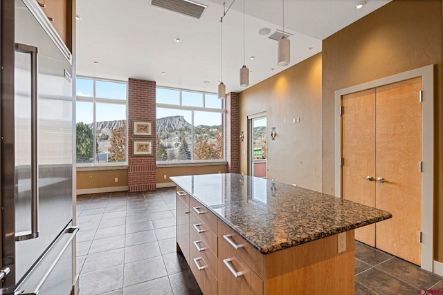 kitchen featuring a mountain view, built in refrigerator, plenty of natural light, and a kitchen island