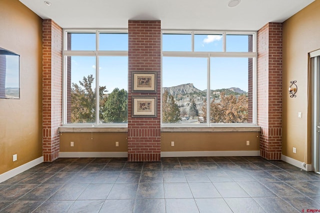 unfurnished living room featuring a mountain view