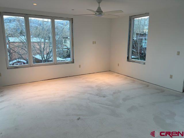 unfurnished room with ceiling fan