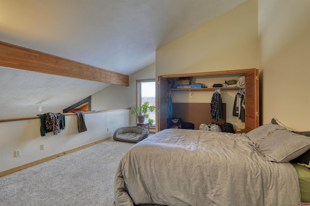 carpeted bedroom featuring lofted ceiling with beams and a closet