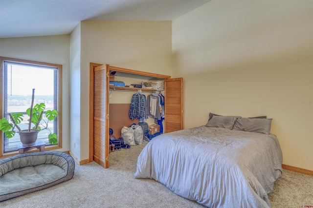 carpeted bedroom featuring a closet and lofted ceiling