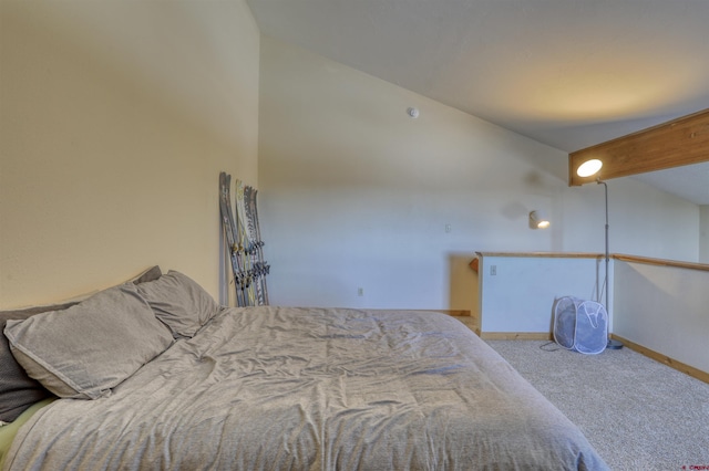 bedroom featuring light carpet and vaulted ceiling