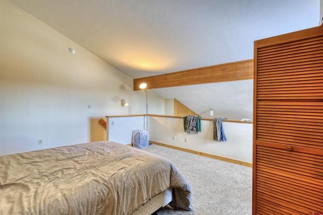 bedroom with carpet flooring and vaulted ceiling with beams