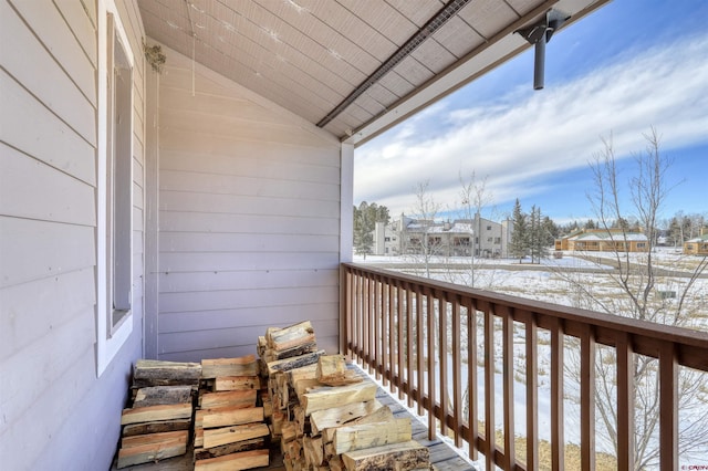 view of snow covered back of property