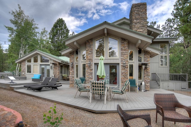 back of property with a wooden deck