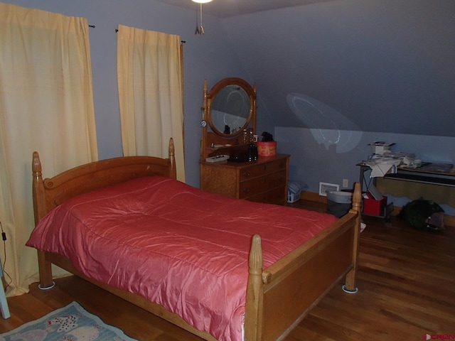 bedroom featuring vaulted ceiling and wood finished floors