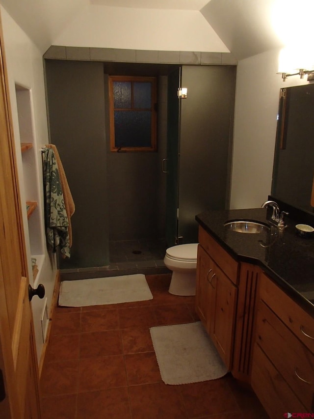 bathroom with toilet, a stall shower, vanity, and tile patterned floors