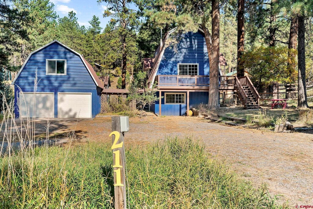 view of front of property with a deck and a garage