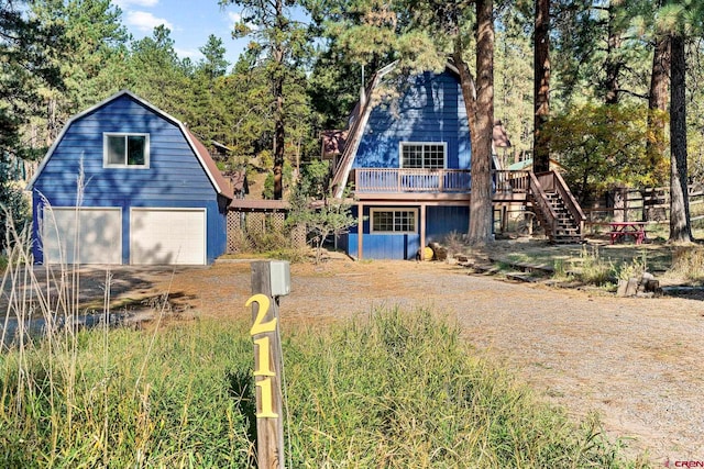 view of front of property with a deck and a garage