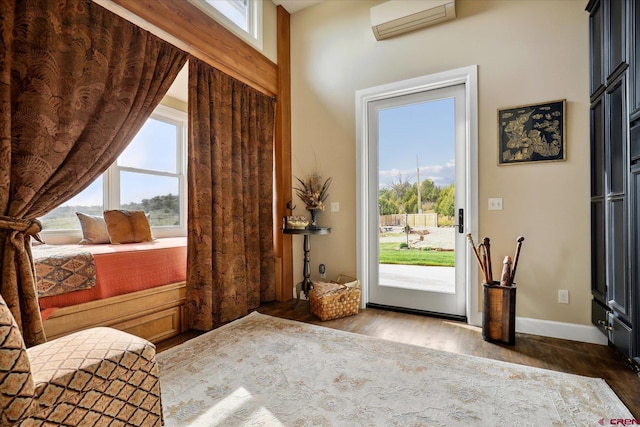 entryway featuring an AC wall unit and dark wood-type flooring