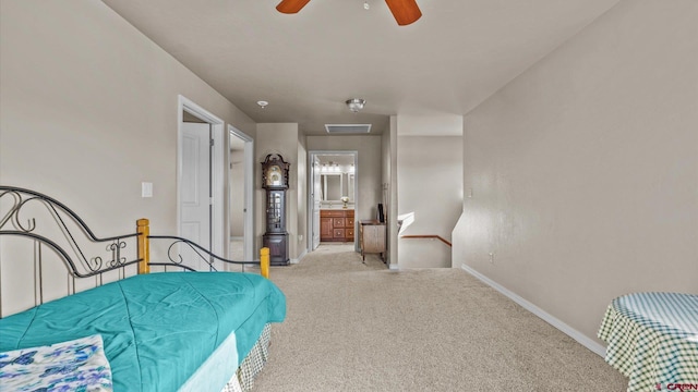 bedroom featuring ceiling fan, light carpet, and connected bathroom