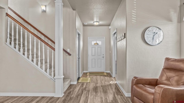 foyer entrance featuring light hardwood / wood-style floors and a textured ceiling