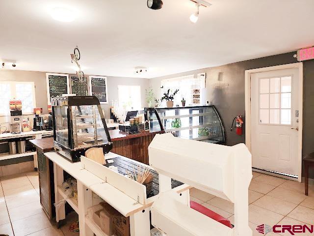 interior space with light tile patterned flooring and a healthy amount of sunlight