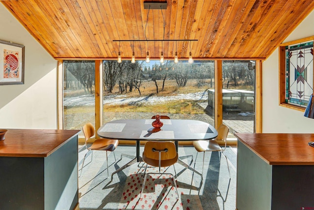 sunroom with wood ceiling, a healthy amount of sunlight, and vaulted ceiling