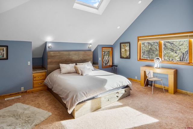 carpeted bedroom featuring lofted ceiling with skylight