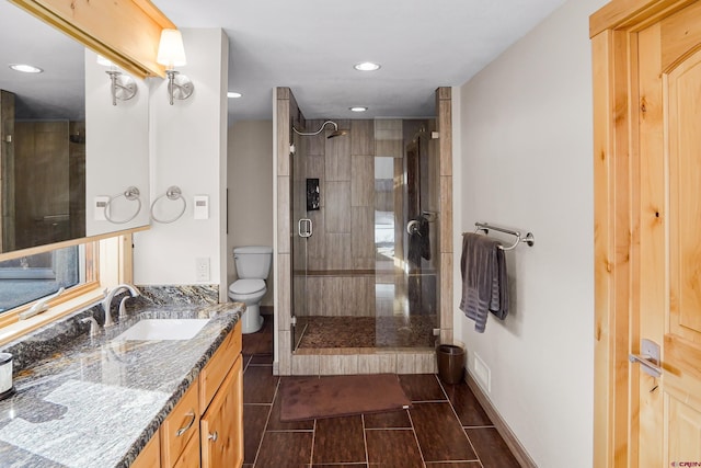 bathroom featuring vanity, toilet, and walk in shower