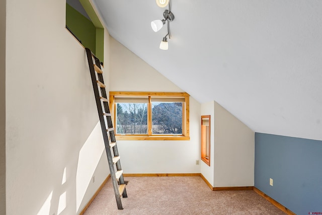 bonus room with carpet floors and vaulted ceiling