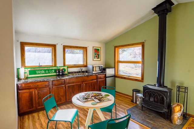 kitchen with a healthy amount of sunlight, sink, light hardwood / wood-style floors, and stainless steel appliances