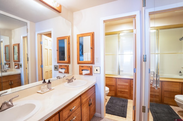 full bathroom with tile patterned floors, vanity, enclosed tub / shower combo, and toilet