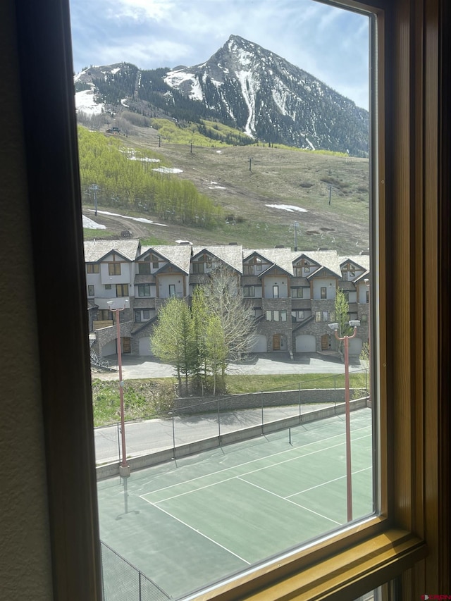 view of tennis court with a mountain view